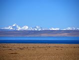 05 Lake Manasarovar And Sangthang and Peaks Of Indian Himalaya From First View Of Mount Kailash The Indian Himalaya stands above the blue waters of Lake Manasarovar seen from the crest of the small hill that has the first view of Mount Kailash. The tallest peak on the left is Sangthang (6480m) situated on Indo-Tibet border.